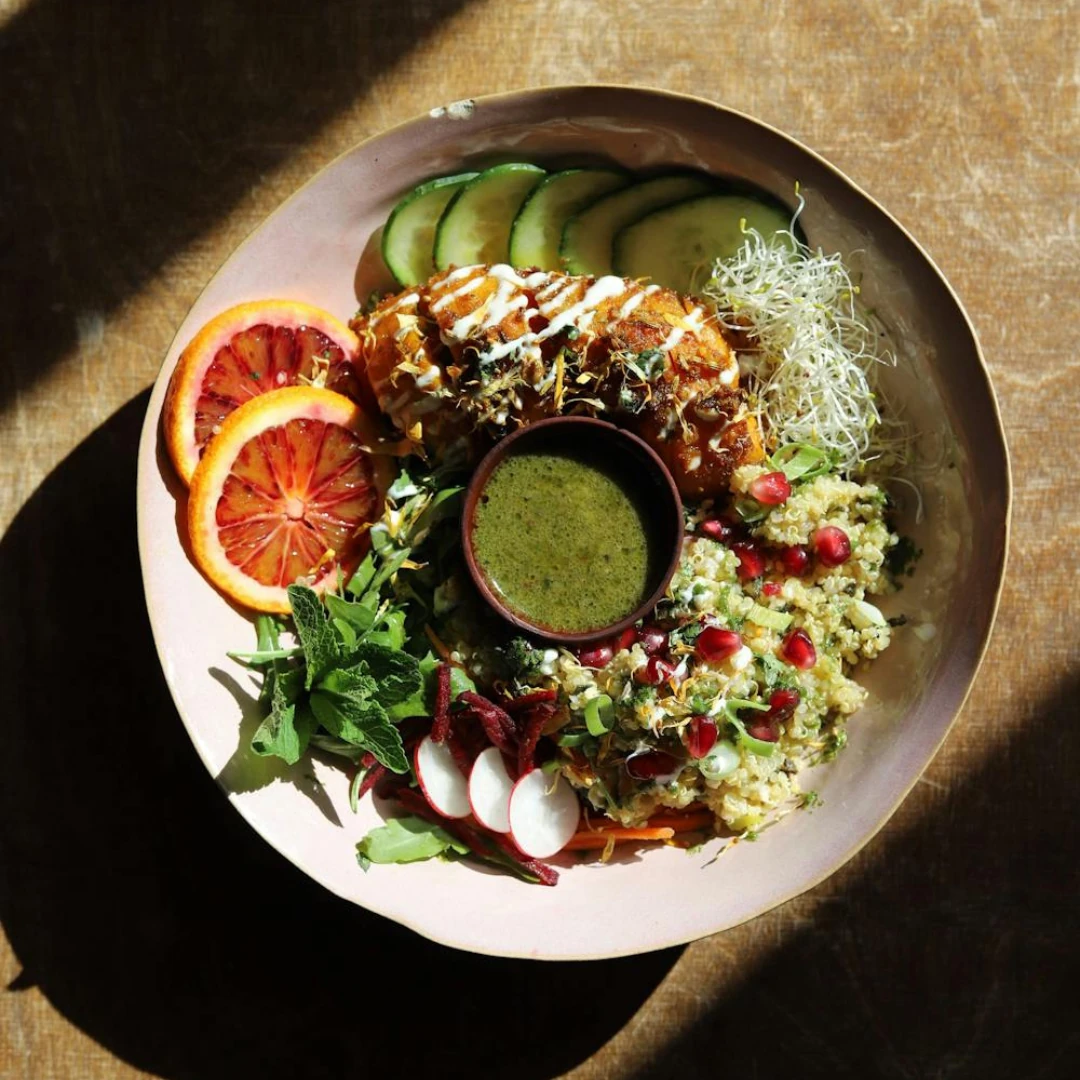 A vibrant sauerkraut salad with shredded carrots, red cabbage, and fresh herbs in a white bowl.
